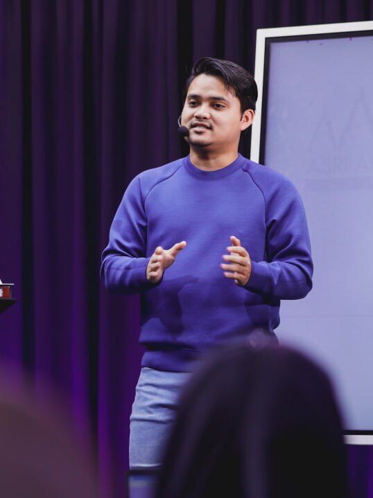 Mobile screen displaying stock market analysis with financial charts in the background.